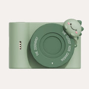 The Zoofamily Urban Zoo Dino camera with a pale green body, dark green round lens cover and small dinosaur detail.